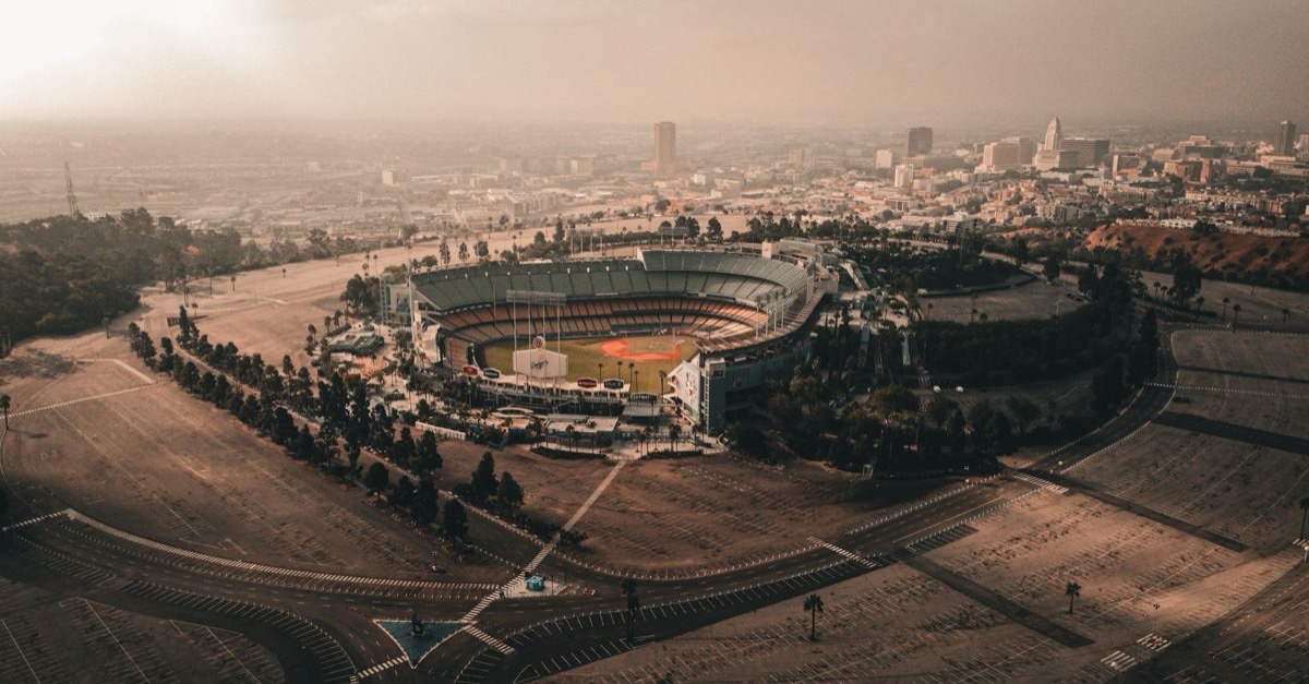 Aerial view of Dodger Stadium with downtown Los Angeles in the haze behind it